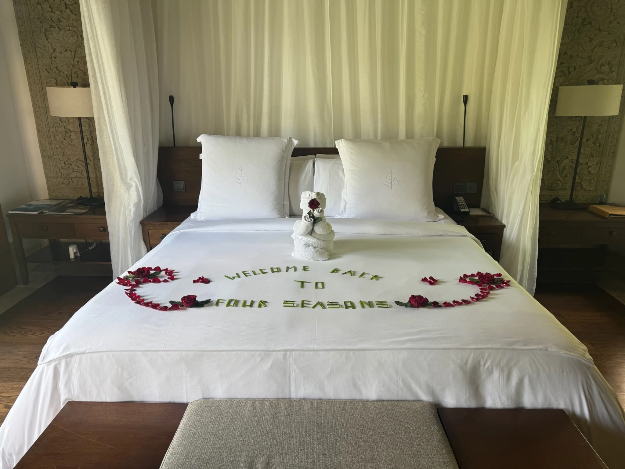 Floral welcome arrangement prepared on a guest bed during a Bali stay.