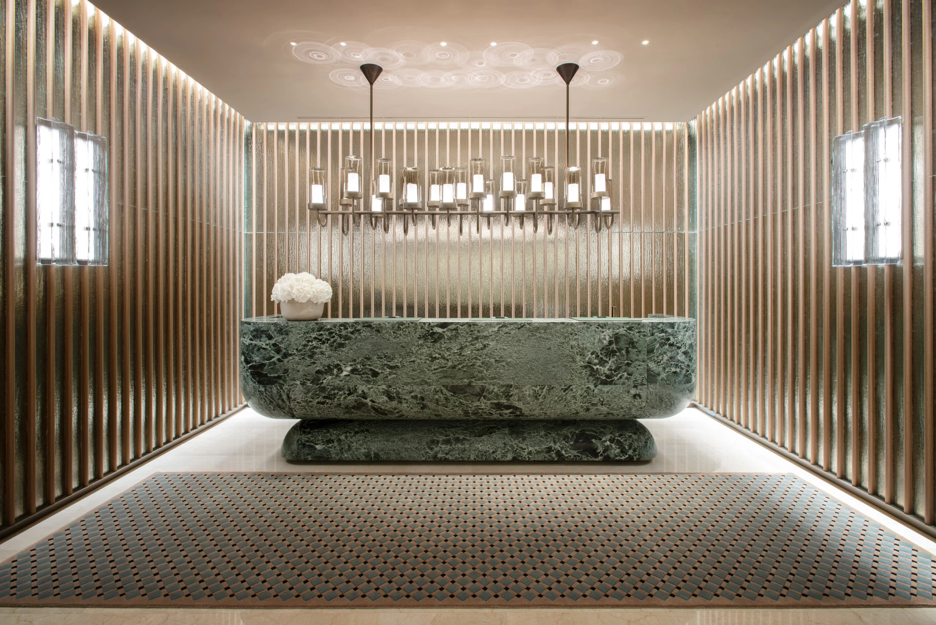 Luxury reception desk at Four Seasons Hotel Milano, illustrating anticipatory five-star hospitality.